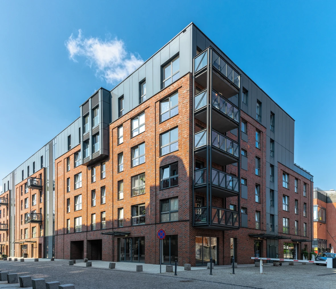 Modern brick apartment building with balconies.