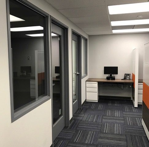 Empty office corridor with single workstation