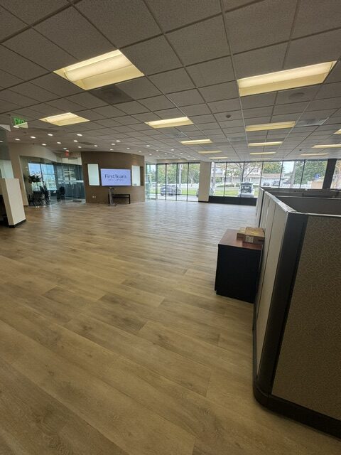Spacious office lobby with wooden flooring.