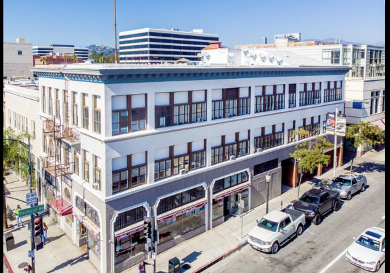 Three-story building on a busy street corner.
