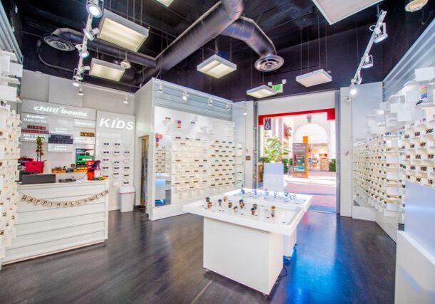 Bright eyewear store interior with display shelves.