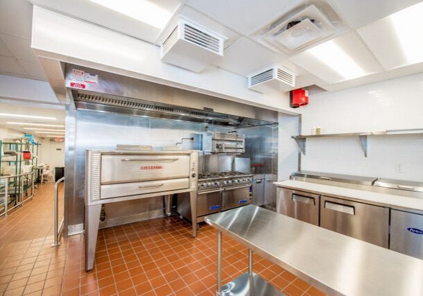 Commercial kitchen with stainless steel appliances.