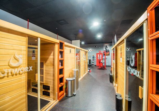 Sauna room with modern gym equipment visible.
