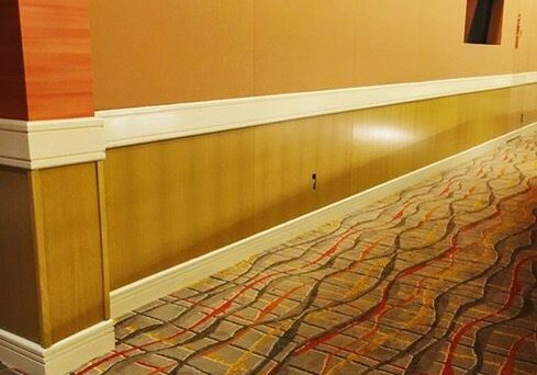 Hotel hallway with patterned carpet flooring.