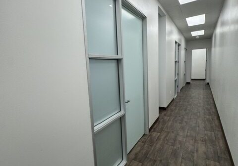 Long hallway with closed office doors.